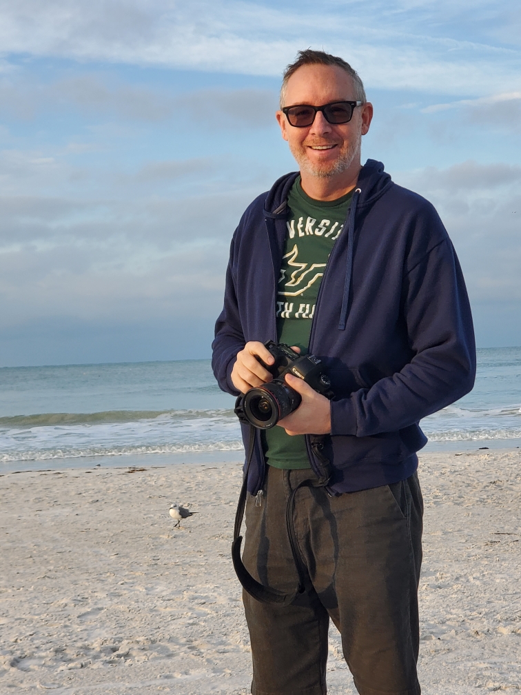 John Mullenix with his camera at the beach